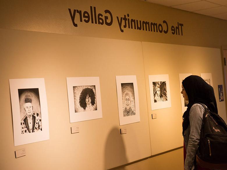 student viewing an exhibit in the community gallery